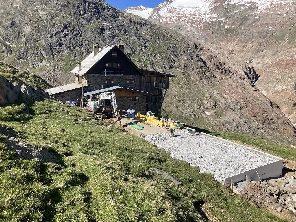 Panorama mit Langtalereckkhütte, halbfertiger Bodenplatte und den Bergen im Hintergrund | © DAV Karlsruhe